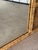 A stunning monumental vintage Buri and rattan wall mirror showcasing six beautifully handwoven sunburst panels that frame...