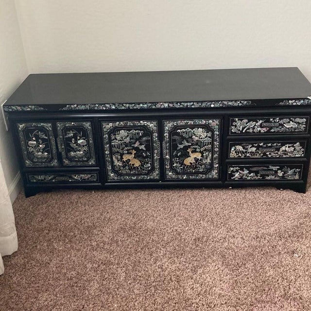 This unique dresser features detailed Asian-inspired designs with mother of pearl inlay on a black lacquer finish. It has...