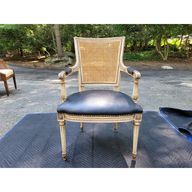 Pair of custom French neo-classical style armchairs. Intricate cane back. Black leather seats and arm pads. Extensive hand...