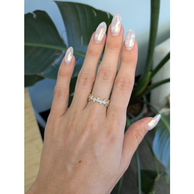 Thirteen pear-shaped lab grown diamonds totalling 1.91 carats sparkle across this solid 14K yellow gold band, their...