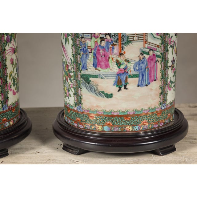 A pair of vintage hand-painted rose medallion Chinese table lamps depicting court scenes, birds and flowers in green, pink...