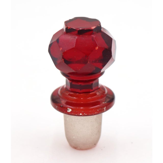 Vintage ruby red faceted glass stopper featuring an octagonal cut head and a frosted dauber. Good condition with surface...