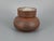 A vase * Made of reddish-brown stoneware with an additive * Interesting, coarse surface texture * White glazed interior *...
