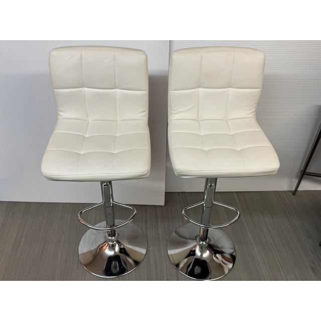 Design Plus Gallery presents a Pair of Bellatier Bar Stools from Ashley Furniture. These sleek and modern chrome-finished...