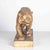 Beautiful large terracotta sculpture with patina representing a lioness on the lookout signed on the base H.BARGA. This...