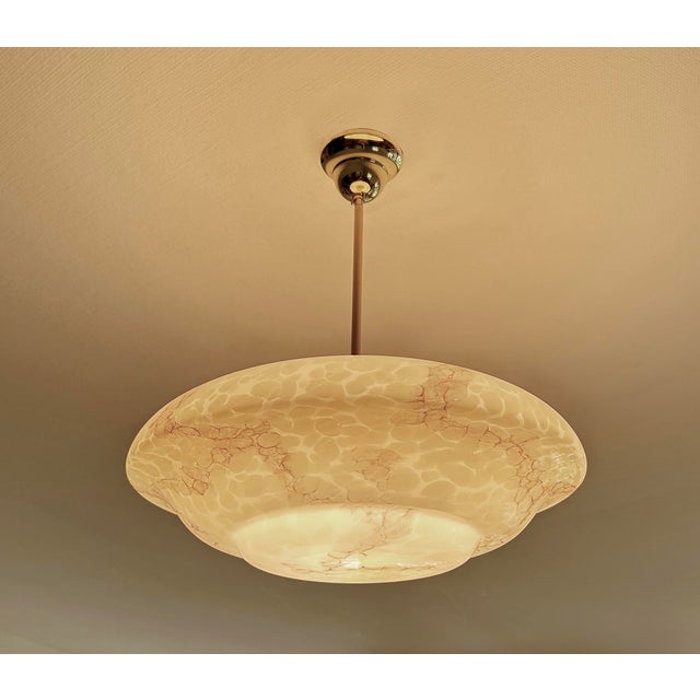 Large Art Deco pendant lamp featuring an ivory / light amber marble glass shade with darker veins, translucent ivory color...