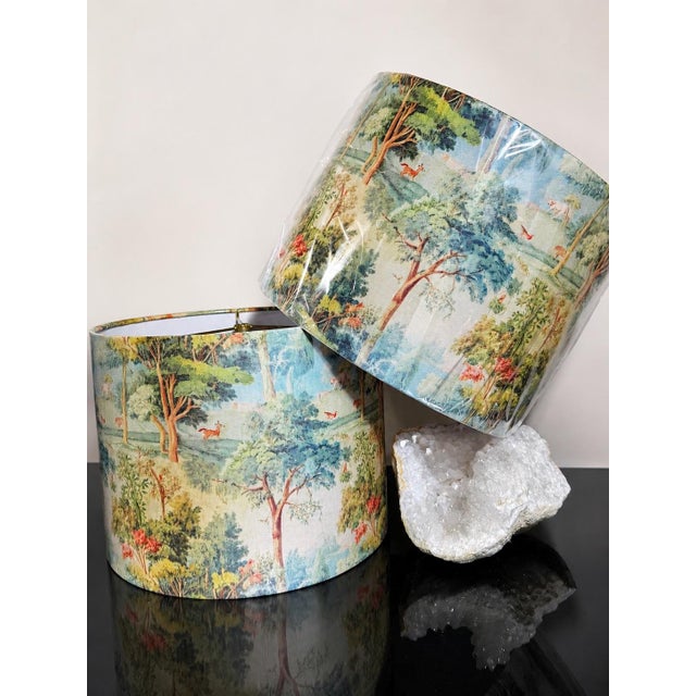 A pair of custom oversized drum lampshades featuring a romantic scenic landscape print rendered in soft shades of blue,...