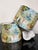 A pair of custom oversized drum lampshades featuring a romantic scenic landscape print rendered in soft shades of blue,...