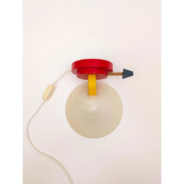 Iconic Memphis style wall or table lamp, designed by Ettore Sottsass in the 1980s. Sottsass founded the Memphis Group in...