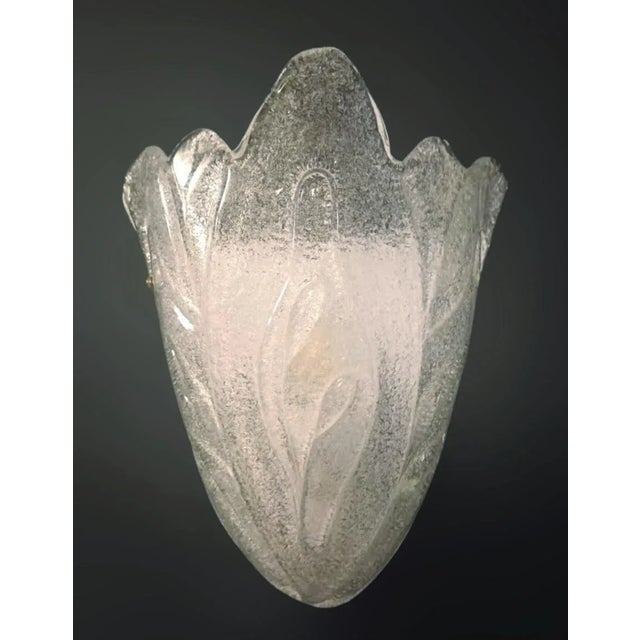 Italian wall light with a Murano glass shield hand blown in Graniglia technique to produce granular textured effect,...