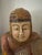 Stunning wood carved Asian figure holding a fish. Polychrome finish. Measures 20” h x 14” w x 6.5” d. Crackling paint,...