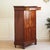 This elegant mahogany secretary desk, featuring a refined interior layout, dates stylistically to the early 19th...
