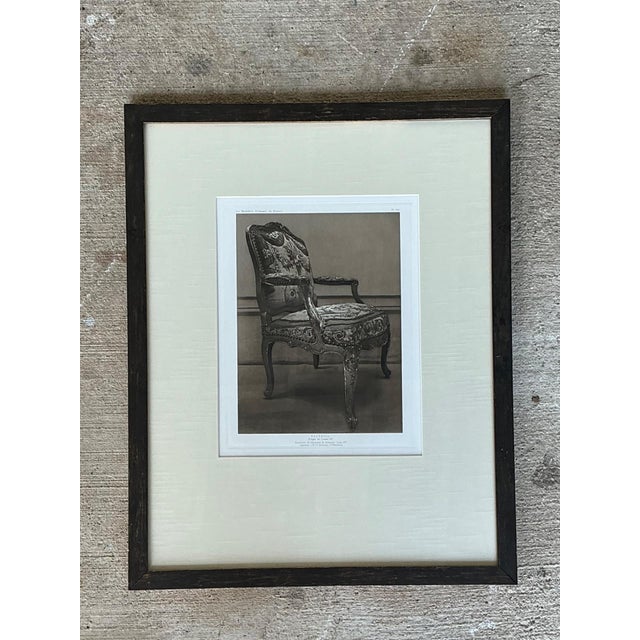 This refined framed antique print depicts a finely detailed French chair, capturing the elegance and decorative...