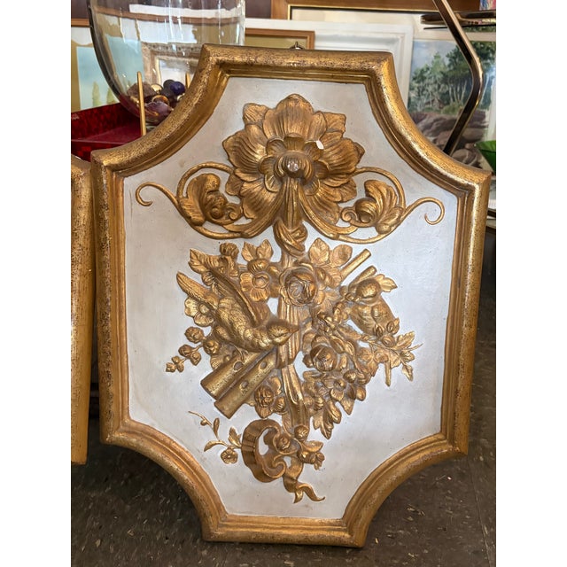 Borghese Italian wall plaques with gilt relief decoration on shaped frames. Well-scaled architectural accents with classic...