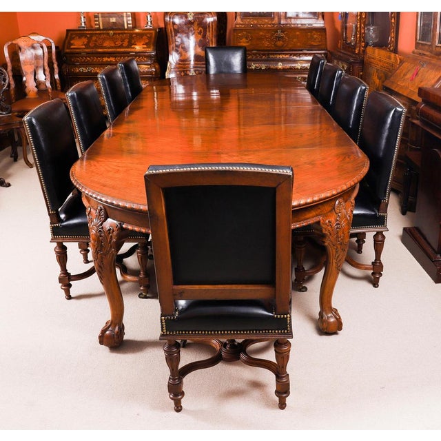 This is a fabulous dining set comprising an antique Queen Anne Revival burr walnut dining table, by the renowned retailer...