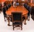 This is a fabulous dining set comprising an antique Queen Anne Revival burr walnut dining table, by the renowned retailer...