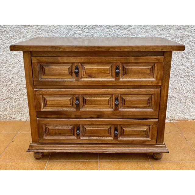 Spanish Baroque chest of drawers in solid wood, featuring three drawers with geometric panelled fronts and original metal...