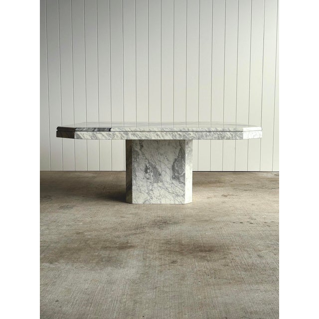 A geometric vintage marble coffee table from Italy, with white Carrara and grey Bardiglio marble pieced together across...
