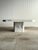 A geometric vintage marble coffee table from Italy, with white Carrara and grey Bardiglio marble pieced together across...