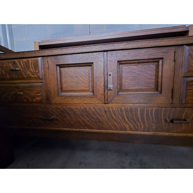 This Arts & Crafts-style solid oak buffet (or sideboard) was made by J. K. Rishel Company of Williamsport, Pennsylvania...