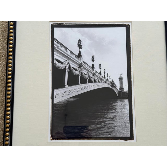 This set of four black and white Parisian photographs beautifully framed in heavy black and gilt wooden frames depicting...