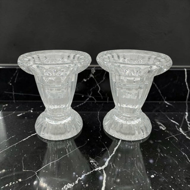 A pair of vintage clear pressed glass candle holders. Featuring a striking fluted, ribbed design with a wide flared rim...