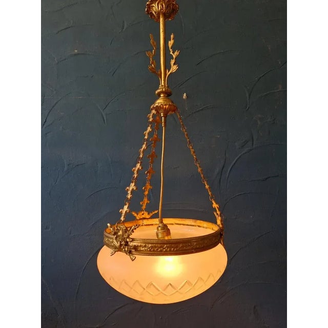 Classic Art Nouveau ceiling lamp with plenty of decorations. Large glass body with pompous brass suspension. Beautiful...