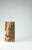 In Levature, the solidity of the stone is traversed by two precise incisions that accommodate burnished metal elements,...