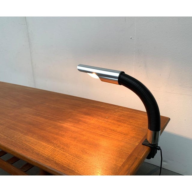 Space age table lamp with table clamp. The head of the lamp is flexible via a swan neck. The contrast between the black...