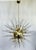 Italian modern Sputnik chandelier with clear Murano glass shards spikes, mounted on unlacquered natural brass finish frame...