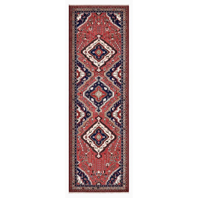 Antique hand-knotted runner from the Hamedan region of western Iran, featuring three stepped diamond medallions arranged...