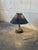 A sculptural flared base and a pleated shade give this compact table lamp a classic organic silhouette. Vibrant glazed...