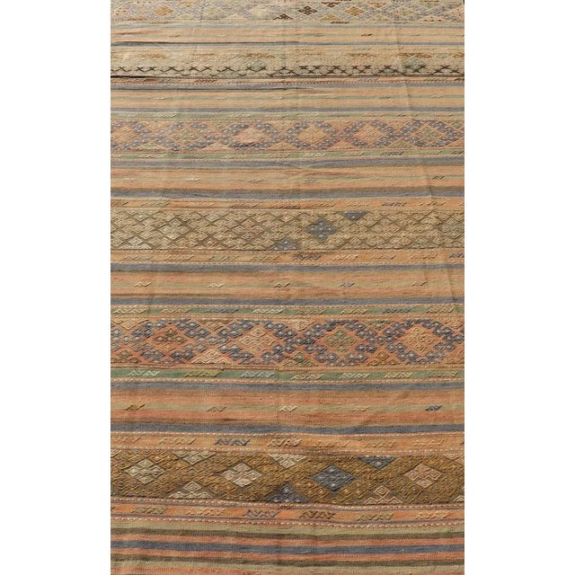 Vintage Striped Turkish Kilim Rug with Geometric Shapes and Soft Muted Colors. Vintage Turkish Kilim rug with geometric...