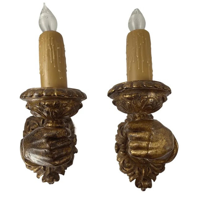 A beautiful pair of hand carved giltwood baroque Italian 17th century arm sconces. Intricately carved floral bases and...