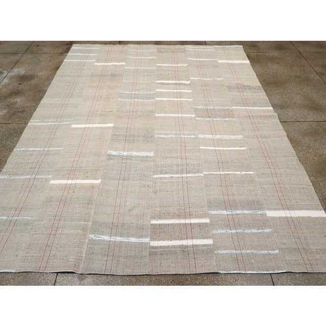 This mid-20th century Turkish Flatweave Kilim rug, features a beautifully restrained design that reflects the elegance of...