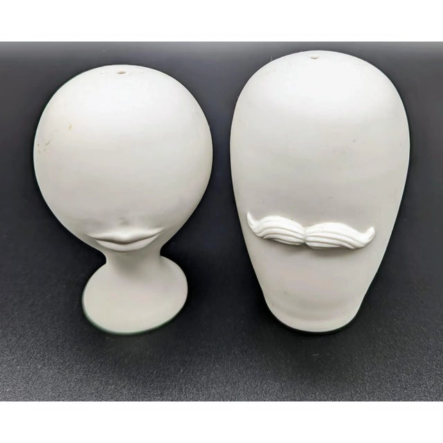 Made of matte white porcelain, this is a pair of Jonathan Adler's whimsical salt and pepper shakers known as Mr & Mrs...