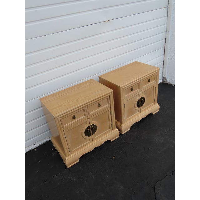 This Pair of Nightstands is made of wood, solid wood, oak, veneer, and metal. The Nightstands were made by Bernhardt...