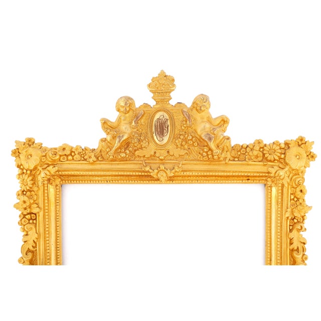 French Louis XV Style Dore Bronze Picture Frame. Frame features rich ornamentation with finely cast floral garlands,...