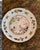 Tin glazed earthenware plate painted in polychrome with a chinoiserie landscape at the center, showing a pavilion, sailing...