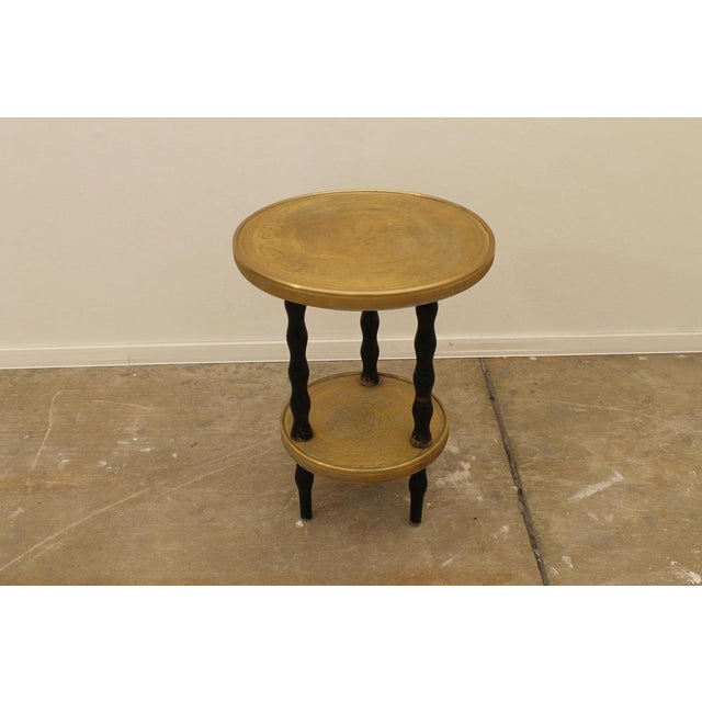 This side table was made around the 1930s and has a wooden structure, turned wavy walnut wooden legs painted black. The...