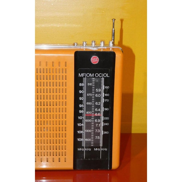 Particular portable radio in ocher and black colored plastic with reception of four different frequencies. it works both...