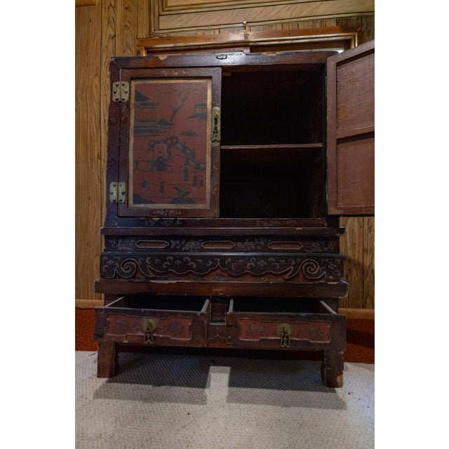 19th Century Chinese Red Lacquer Wedding Cabinet A striking antique Chinese wedding cabinet finished in rich red lacquer...