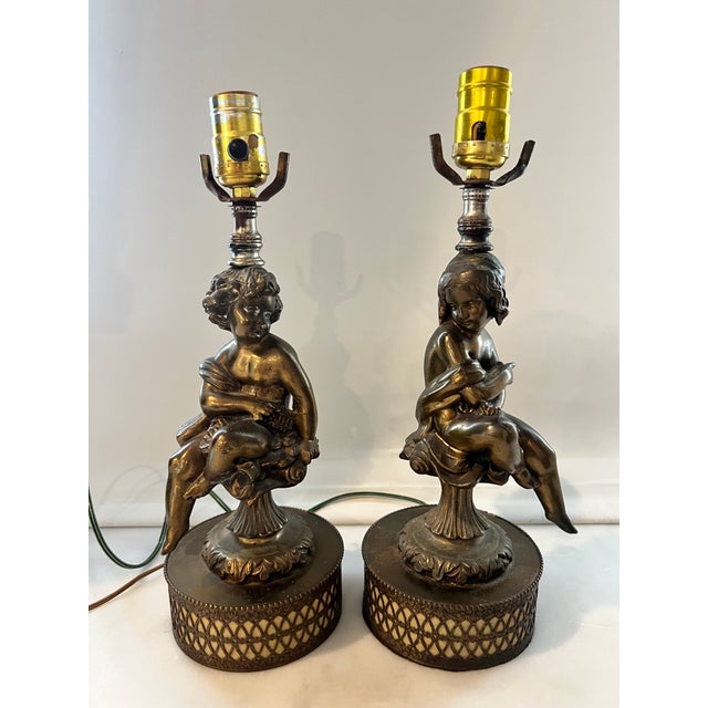 A pair of vintage cherub Figaro metal lamps in French style