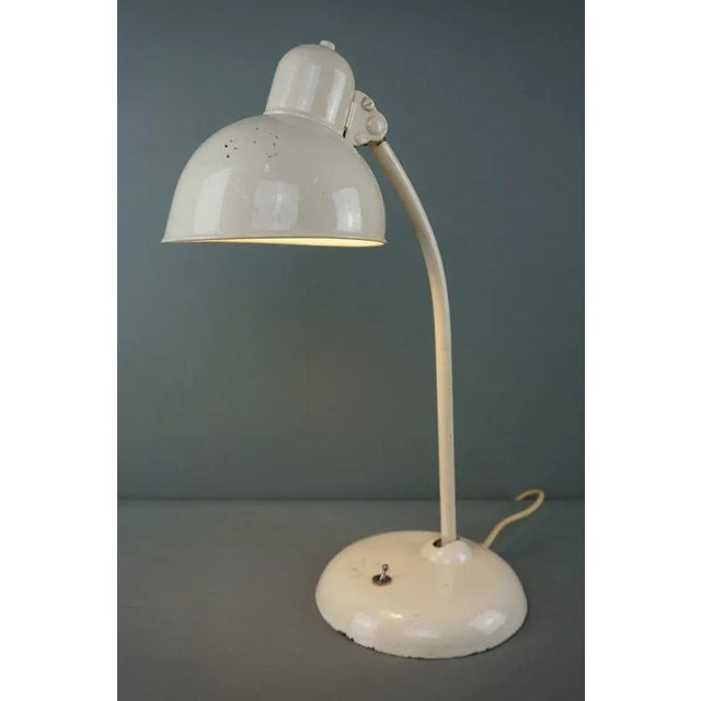This table lamp model 6551, after a design by the Bauhaus artist Christian Dell for the Lampenfabriek Gebr. Kaiser & Co is...