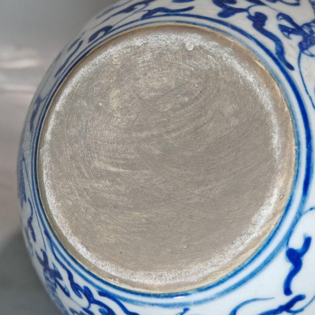 Add a piece of classic Asian artistry to your home with this striking blue and white porcelain jar. The vessel features a...