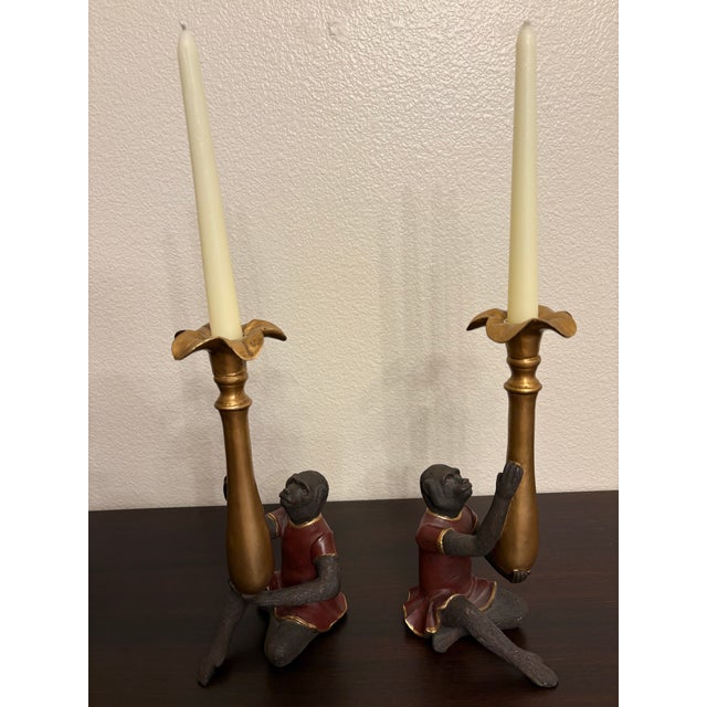 These mid century modern vintage butler monkey candleholders, Bill Huebbe style red coat candlesticks are classic examples...