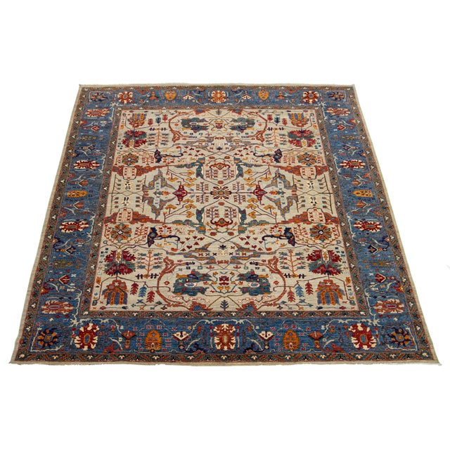 This beautiful room-sized rug features a modern interpretation of the classic Serapi style, crafted from high-quality...