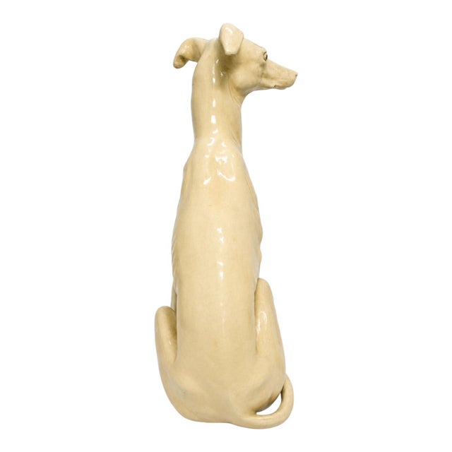 This is a monumental Hollywood Regency era seated greyhound. It is composition and may be Marwal. It is ivory and in very...
