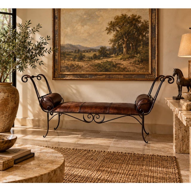 Striking vintage rustic bench featuring an elegant wrought iron frame with dramatic scrolled arms and decorative ironwork...