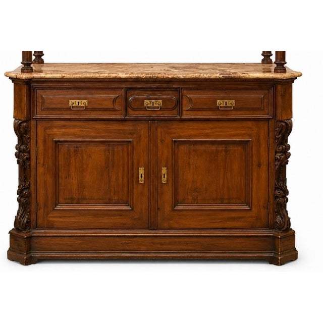 Portuguese, 19th century, in mahogany wood, with three drawers and two doors. Marble top. Bronze hardware. Minor flaws and...